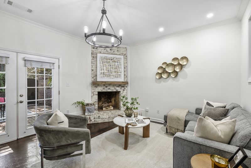 Living room with the wood-burning fireplace and French doors to the courtyard