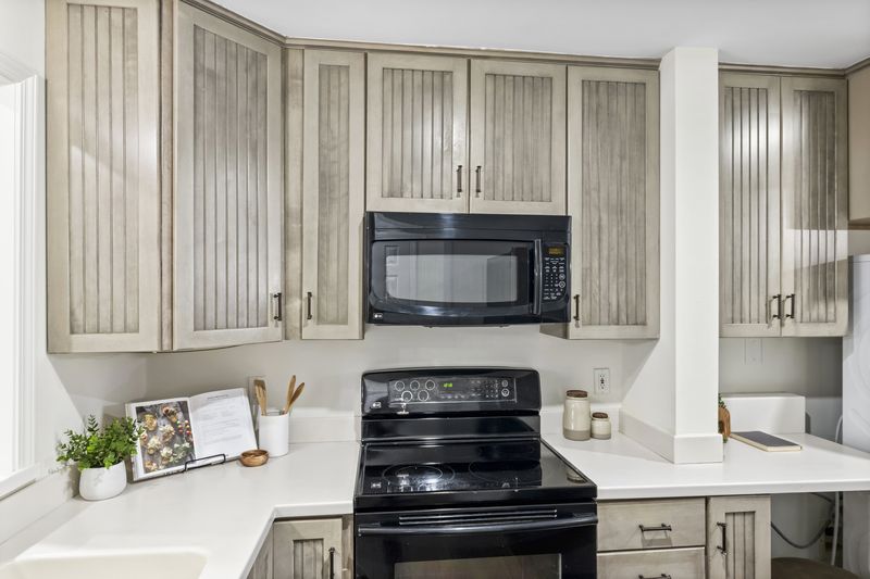 Kitchen with soft greige cabinetry and a range