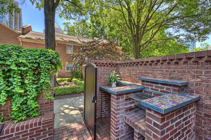 Courtyard with a built-in grill and brick walls